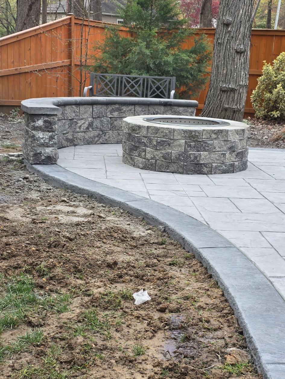 Fire pit and curved seat wall on a stamped patio
